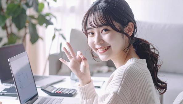 家計がうまくいきスマホ片手に微笑む女性 家計がうまくいきスマホ片手に微笑む女性の写真