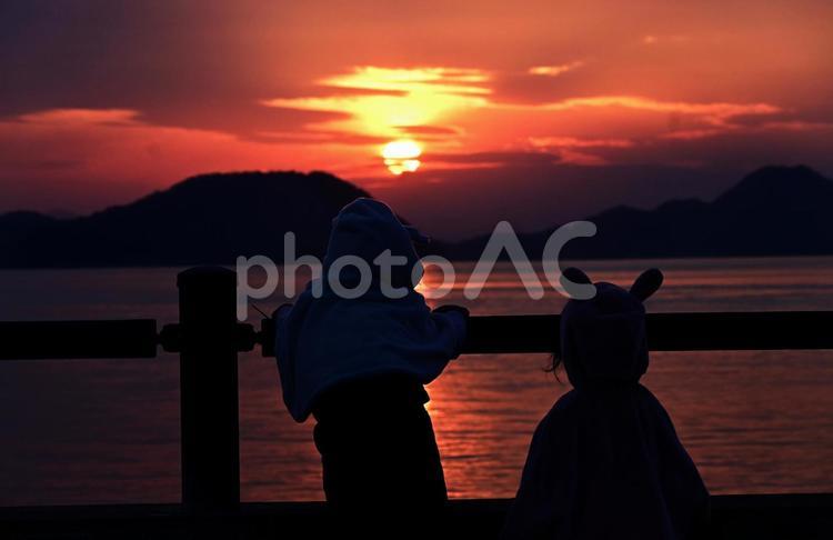 夕焼けを望むうさぎフードの子供たち 夕焼け,サンセット,夕日の写真素材