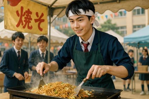 焼きそばを調理する男子高校生の写真