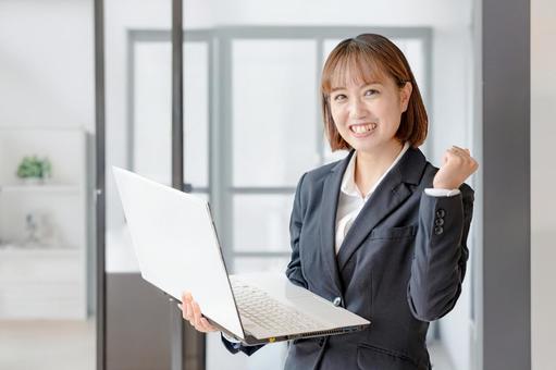 PCと綺麗なオフィスとスーツ女性 PCと綺麗なオフィスとスーツ女性 女性,スーツ,ビジネスの写真素材