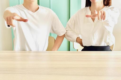 前に指をさす男女二人 前に指をさす男女二人の写真