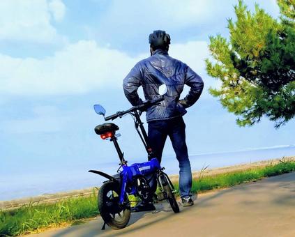 電動自転車を降り、遠くを眺める男性 電動自転車,サイクリング,散策の写真素材