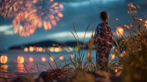 打ち上げ花火を背景に浴衣女性の後ろ姿 打ち上げ花火を背景に浴衣女性の後ろ姿の写真