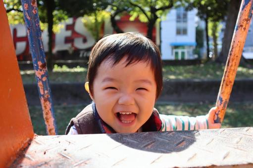 休日の公園の遊具で笑う子供 休日の公園の遊具で笑う子供 子供,男の子,幼児の写真素材