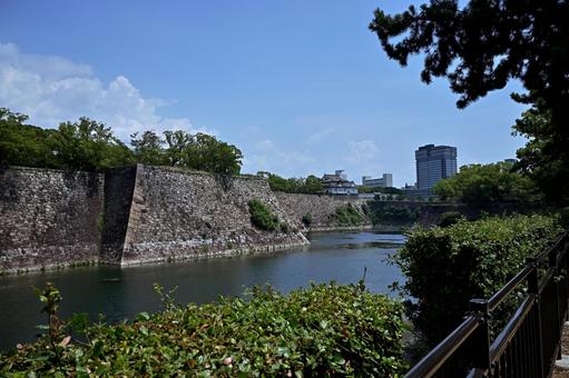 青空の下歴史的大阪城の堀と最新の高層ビル 大阪城,堀,高層ビルの写真素材