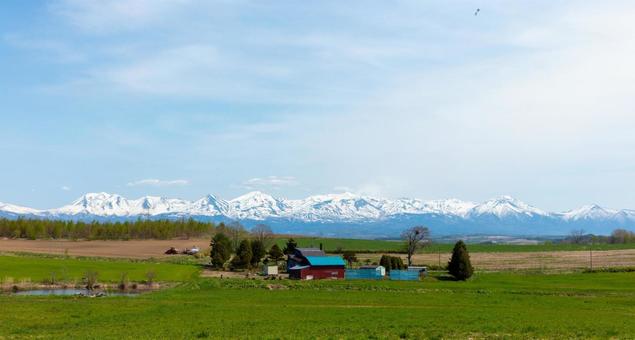 Snow-covered Tokachi mountain range and farm, JPG Snow-covered Tokachi mountain range and farm, JPG