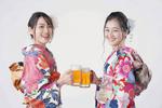 ビールで乾杯する振り袖を着た2人の若い女性　白バック 振り袖,ビール,成人の日の写真素材