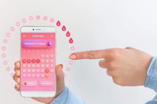 生理周期アプリの画面を指差す女性 生理,月経,女性の写真素材