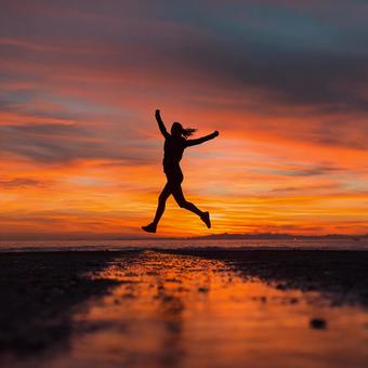 圧倒的な夕焼けを背景にした歓喜の瞬間 圧倒的な夕焼けを背景にした歓喜の瞬間の写真