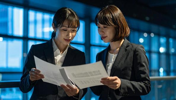 話し合う女性社員二人 話し合う女性社員二人の写真