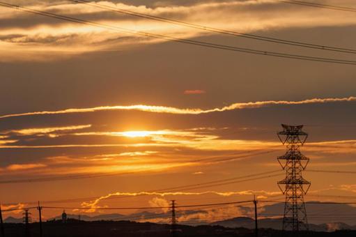 Electricity transmission tower illuminated by the setting sun, JPG