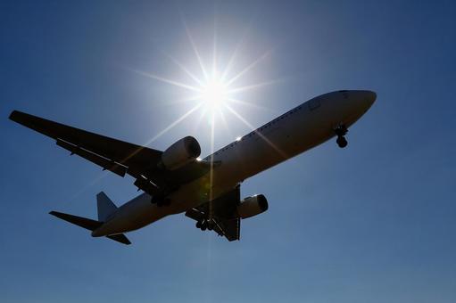 太陽｜青空｜飛行機シルエット 飛行機,航空機,旅客機の写真素材
