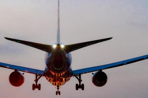 A plane preparing for final landing at dusk, JPG
