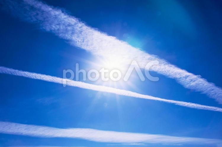 太陽が輝く青空に浮かぶ多くの飛行機雲１ 飛行機雲,ジェット機,ひこうき雲の写真素材