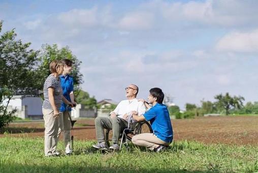 Elderly and caregivers chatting outdoors, senior citizens, wheelchair, nurses, JPG