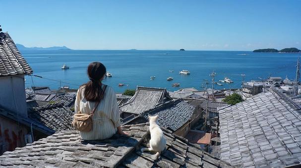 海を眺める女性と猫 海を眺める女性と猫の写真