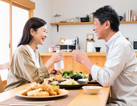晩酌を楽しむ仲良しシニア夫婦 晩酌を楽しむ仲良しシニア夫婦の写真