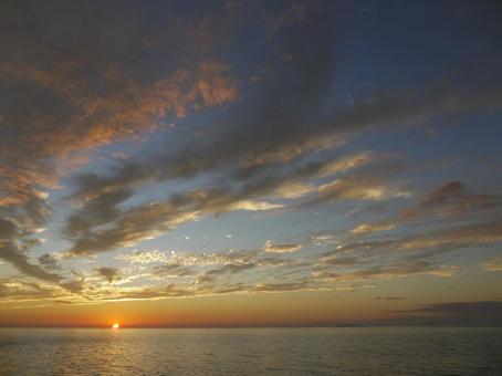 海に沈む夕日と空 空,海,雲の写真素材