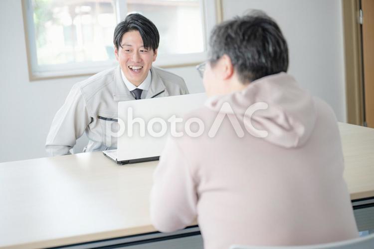 作業服男性と顧客 会話,ミーティング,相談の写真素材