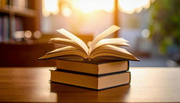 読書イメージ 見開きと積み重なる本 読書イメージ 見開きと積み重なる本の写真