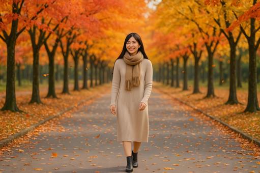 紅葉並木を歩く女性 紅葉並木を歩く女性の写真
