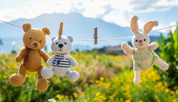 洗濯後に干される熊とウサギのぬいぐるみ 洗濯後に干される熊とウサギのぬいぐるみの写真