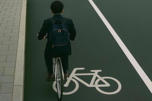 自転車レーンを走行する男子高生 自転車レーンを走行する男子高生の写真