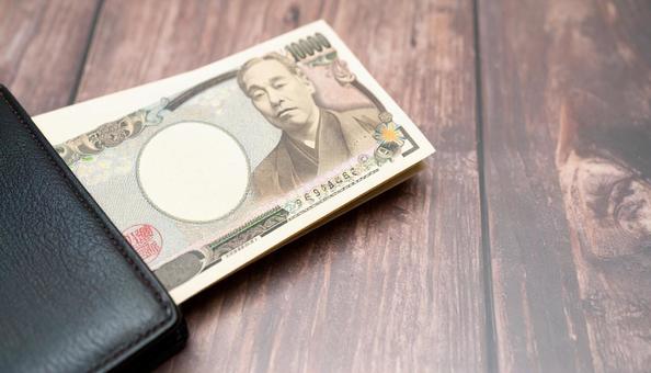 財布に入りきれないお金 大金の一万円札 財布に入りきれないお金 大金の一万円札の写真