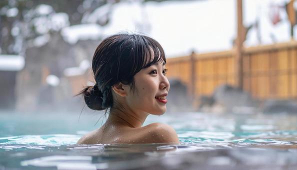 温泉につかってリラックスする若い女性 温泉につかってリラックスする若い女性の写真