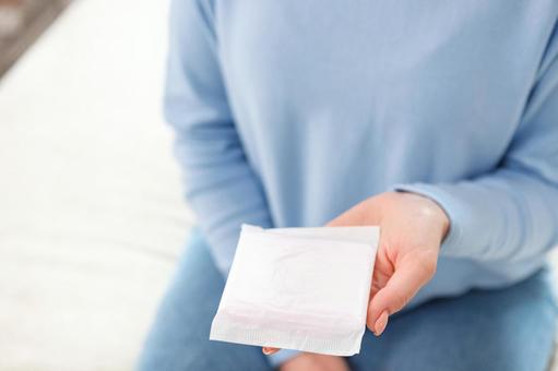 手のひらに生理用ナプキンを乗せている女性 生理,月経,女性の写真素材