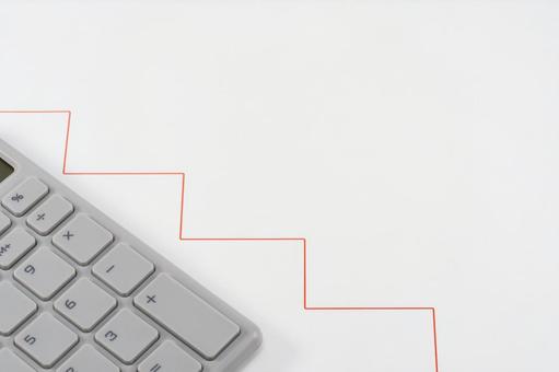 グラフと電卓で価値が下がるイメージ グラフと電卓で価値が下がるイメージの写真