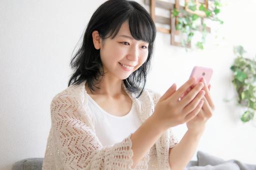 Image of a woman operating a smartphone, matching, female, marriage hunting, JPG