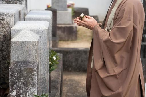 Image of a monk visiting a grave Image of a monk visiting a grave