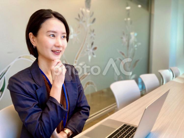 オフィスでミーティングをするスーツの女性 女性,笑顔,会社の写真素材