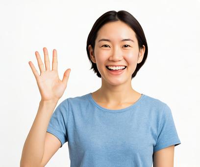 明るい笑顔で挨拶する若い女性 明るい笑顔で挨拶する若い女性の写真