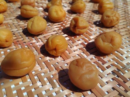 Close-up of pickled plums on a bamboo colander, JPG