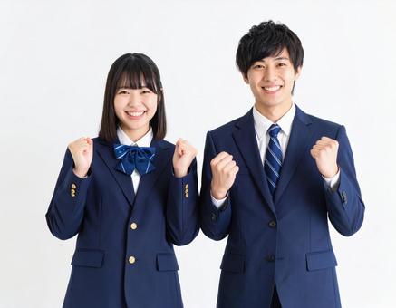 ガッツポーズでエールを送る男女高校生 ガッツポーズでエールを送る男女高校生の写真