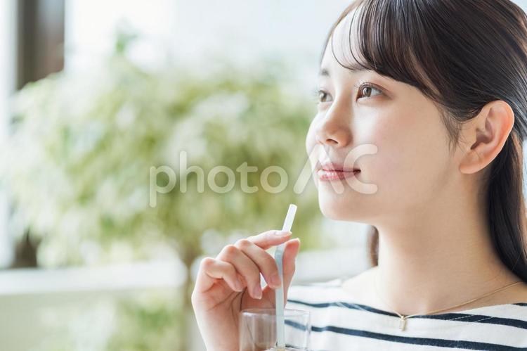 カフェで待ち合わせをする女子大学生。 女性,カフェ,待ち合わせの写真素材