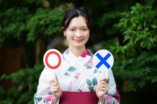 浴衣姿の女性がカードをあげる 女性,浴衣,クイズプレートの写真素材