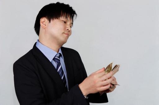 お金を数えるビジネスマン 男性,ビジネスマン,スーツの写真素材