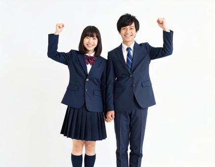 ガッツポーズでエールを送る男女高校生 ガッツポーズでエールを送る男女高校生の写真