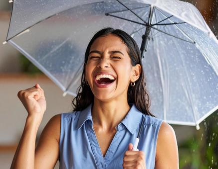 雨の中で笑顔を見せる外国人女性 雨の中で笑顔を見せる外国人女性の写真