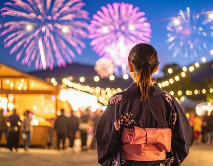 浴衣姿の女性が打ち上げ花火を見上げる 浴衣姿の女性が打ち上げ花火を見上げるの写真