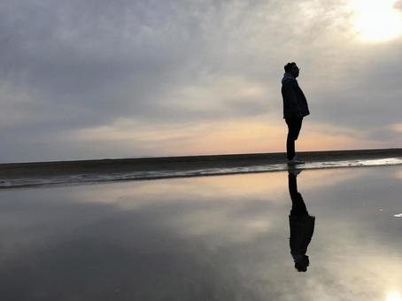 海に沈む夕日と人影 海に沈む夕日と人影の写真