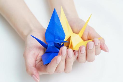 Woman's hands holding origami paper , JPG