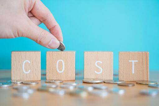 Cost | Hand with building blocks and coins labeled "COST", cost, cost, cost, JPG