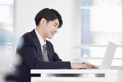 Japanese male businessman working on a laptop with a smile, businessman, a smile, male, JPG