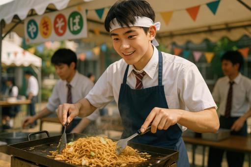 焼きそばを調理する男子高校生 焼きそばを調理する男子高校生の写真