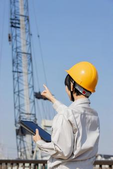 Woman in work clothes at a construction site, JPG
