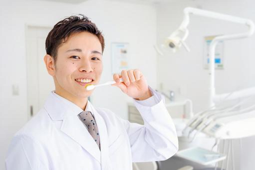 歯科医院と歯ブラシを持った医師 歯科医,歯医者,男性の写真素材